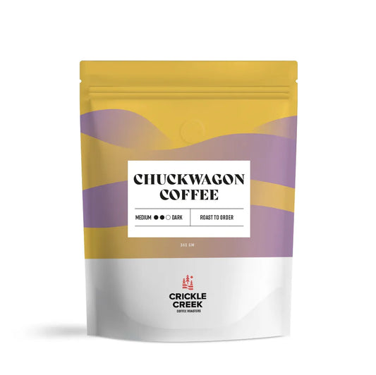 Specialty coffee blend bag labeled 'Chuckwagon Coffee'; curated and roasted by Crickle Creek Coffee.